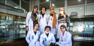 Women in white coats in front of bakery display cases (UNDP)