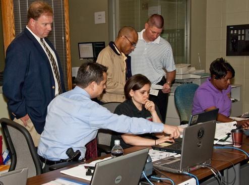 At the command post for the April Tinsley investigation, one of our agents (front left) offers instruction on ORION, our new crisis management system.