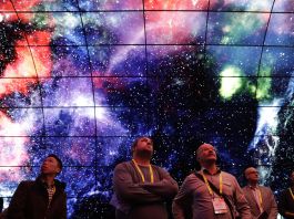 People looking up into image of space (© AP Images)