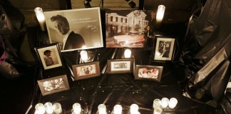Arrangement of candles and framed photographs dedicated to musician Elvis Presley (© AP Images)