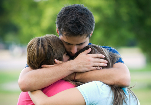 A family hugging after a prisoner's release