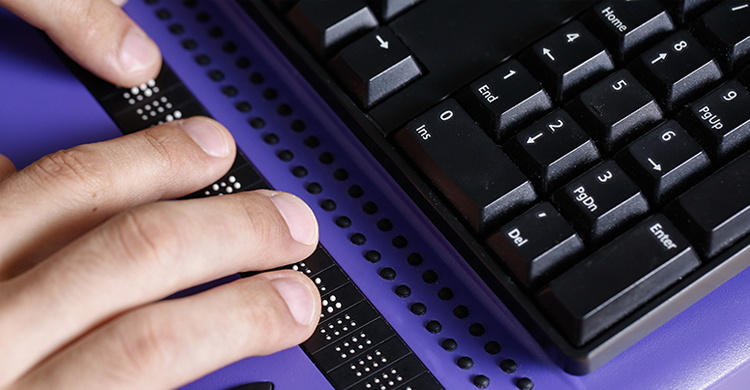 Image of a person's hands while they read braille