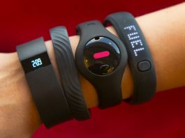 Fitness trackers on an arm (© AP Images)