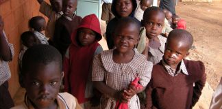 Kenyan children standing outside (© AP Images)