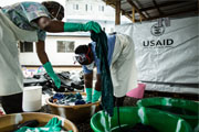 Washing is a vital part of the operation of the Ebola Treatment Unit at Island Clinic in Monrovia. All scrubs worn under PPEs and shoes must be washed thoroughly in chlorine water and then with soap. / Morgana Wingard