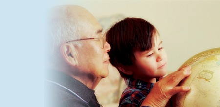 photo of man and boy looking at a globe