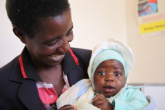 Baby receives health services. Photo credit: USAID