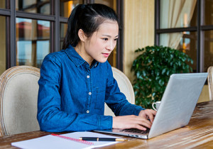 A young woman uses the computer.