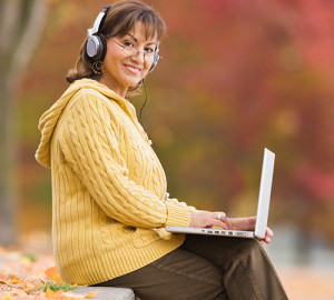 happy woman outside  with lap top
