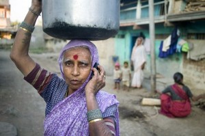 A woman on a phone in India. Photo Credit: USAID