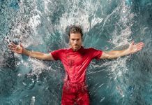 Man wearing soccer uniform falling backward into water (Courtesy of Adidas)