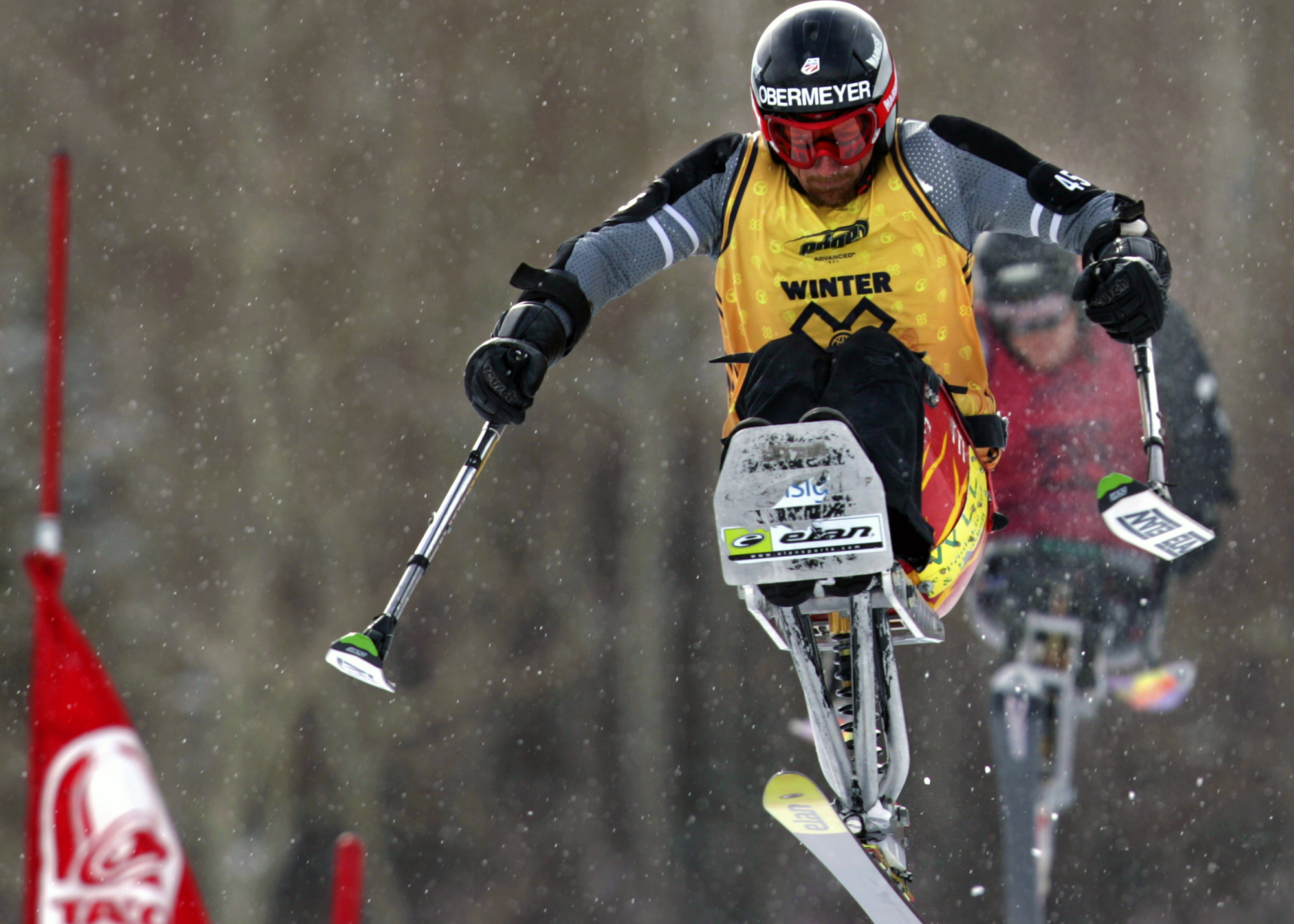 Skiier in air on mono-ski (© AP Images)