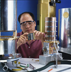 NIST physicist Sae Woo Nam Sae Woo Nam holds a circuit used to amplify signals from the new photon detector. 