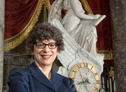 Dr. Michele Cohen stands in front of the Car of History in National Statuary Hall.