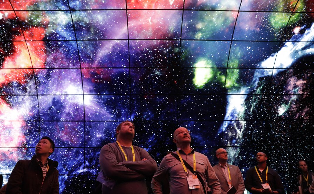 People looking up into image of space (© AP Images)