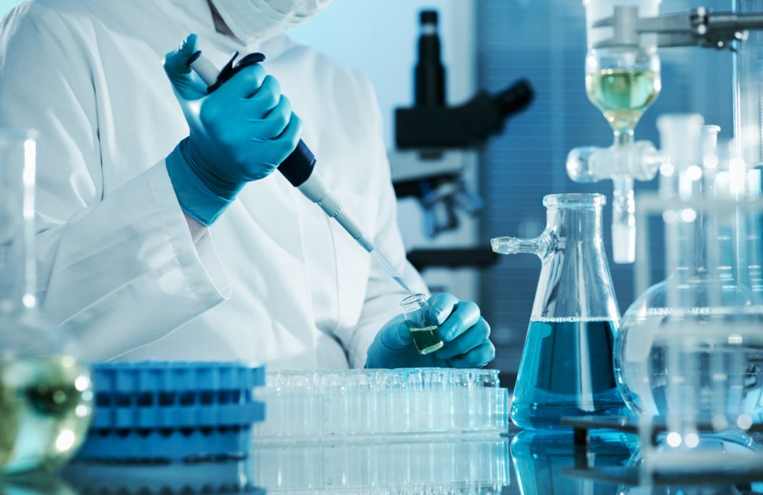 Person working with dropper in lab (Shutterstock)