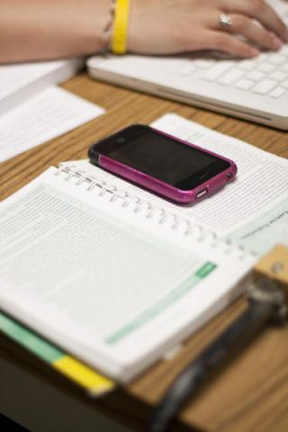 Open notebook with phone on top