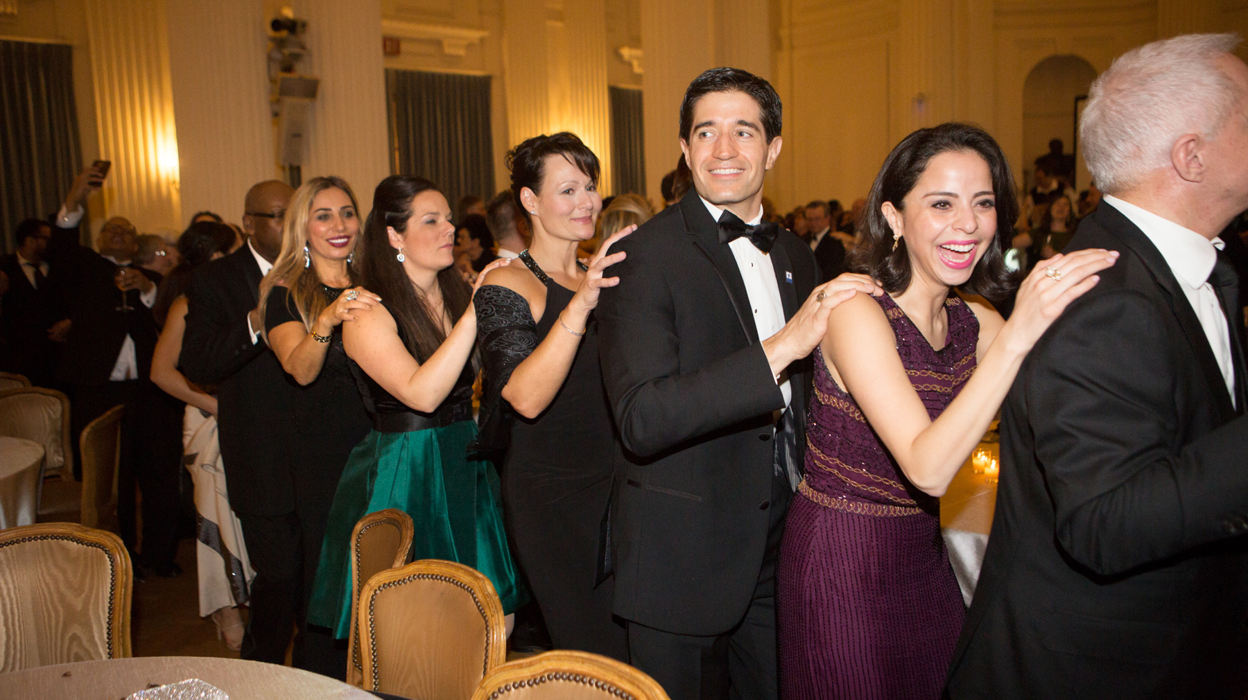 Revelers dancing in conga line (State Dept./D.A. Peterson)