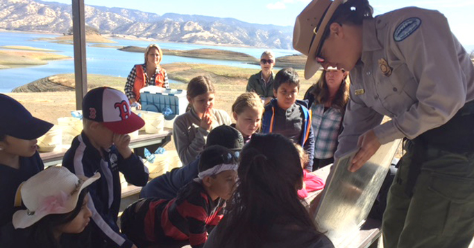 Park rangers teach children visiting the Winters Salmon Festival about Putah Creek