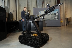 A technician at Idaho National Laboratory demonstrates the modified TALON robot.