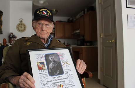 Henry Smith, who served in the 75th Infantry Division in World War II, holds a gift he received when he visited Belgium earlier this year.