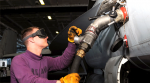 A technician loads an aircraft with jet fuel.