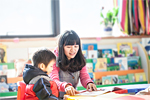 teacher with student in classroom