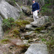 A visitor on a steep informal trail