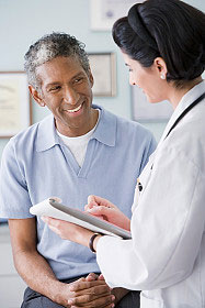 Picture of female clinician speaking with a male patient