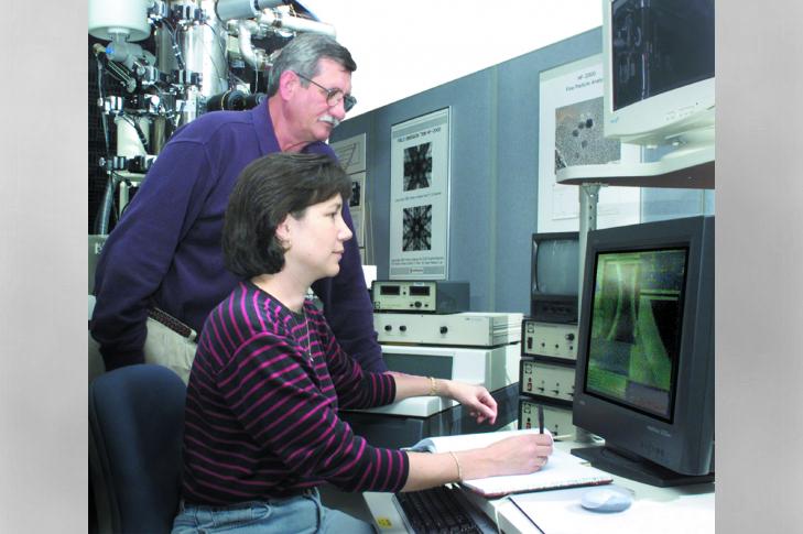During DOE programs to advance industrial ceramic matrix composites, ORNL’s Karren More (foreground, with Larry Walker) used transmission electron microscopy and other techniques.