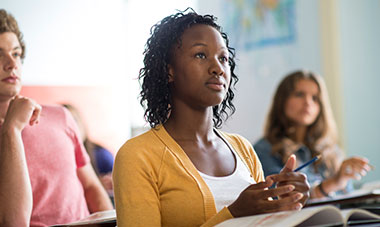 Young lady listening attentively in class.