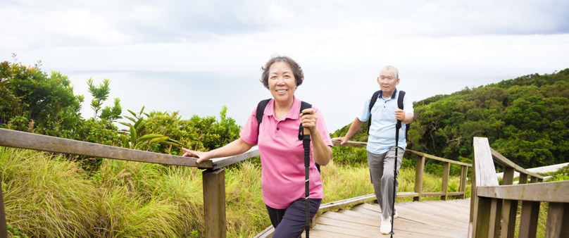 Photo of a senior couple walking up a gently sloped path