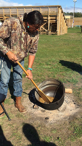 In this demonstration at the Great Lakes Intertribal Food Summit in September 2016, wild rice is hand parched over a wood fire, a key step in the traditional processing of wild rice.