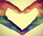 	Two hands forming a heart shape, filled with rainbow-colored stripes