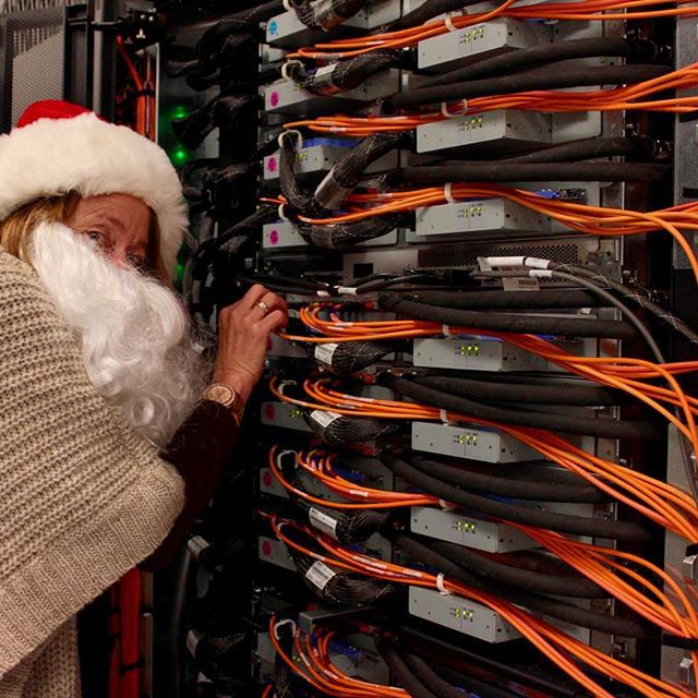 Kim Cupps, acting associate director for Computation, peeks behind Sequoia. As the fourth fastest supercomputer in the world, it rivals Santa's sleigh in speed. Livermore Computing delivers multiple petaFLOP/s of compute power to help solve the world’s biggest problems from performing energy simulations or cybersecurity research to simulating the human heart to understand how different medications affect it. #SantaScience