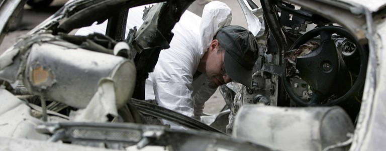 FBI Agent Collects Evidence from Exploded Car in Lebanon (AP Photo)