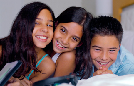 Three young children smiling