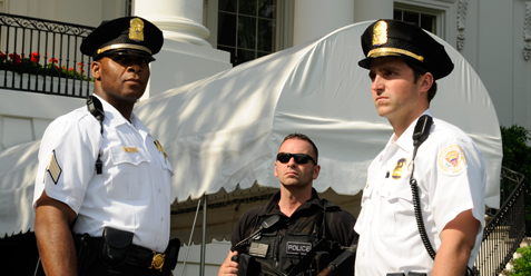 Three Uniformed Division officers standing in front of a building