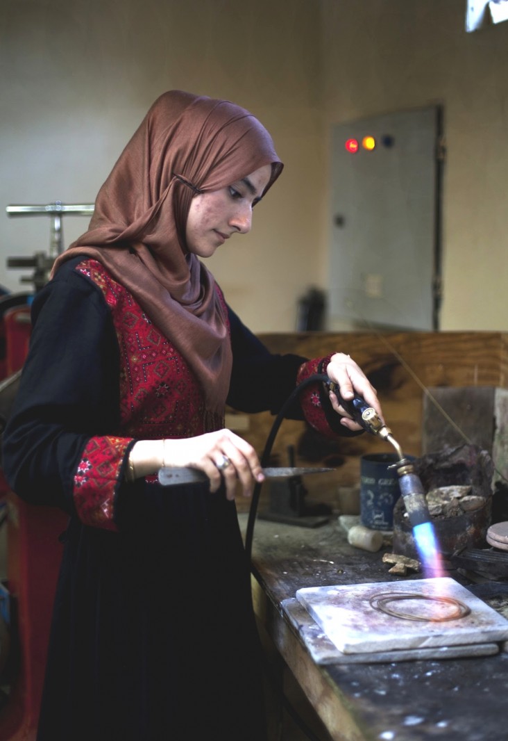 Storai Stanizai, a third-year jewelry student, works on a piece celebrating Ghazni as the 2013 City of Islamic Culture.