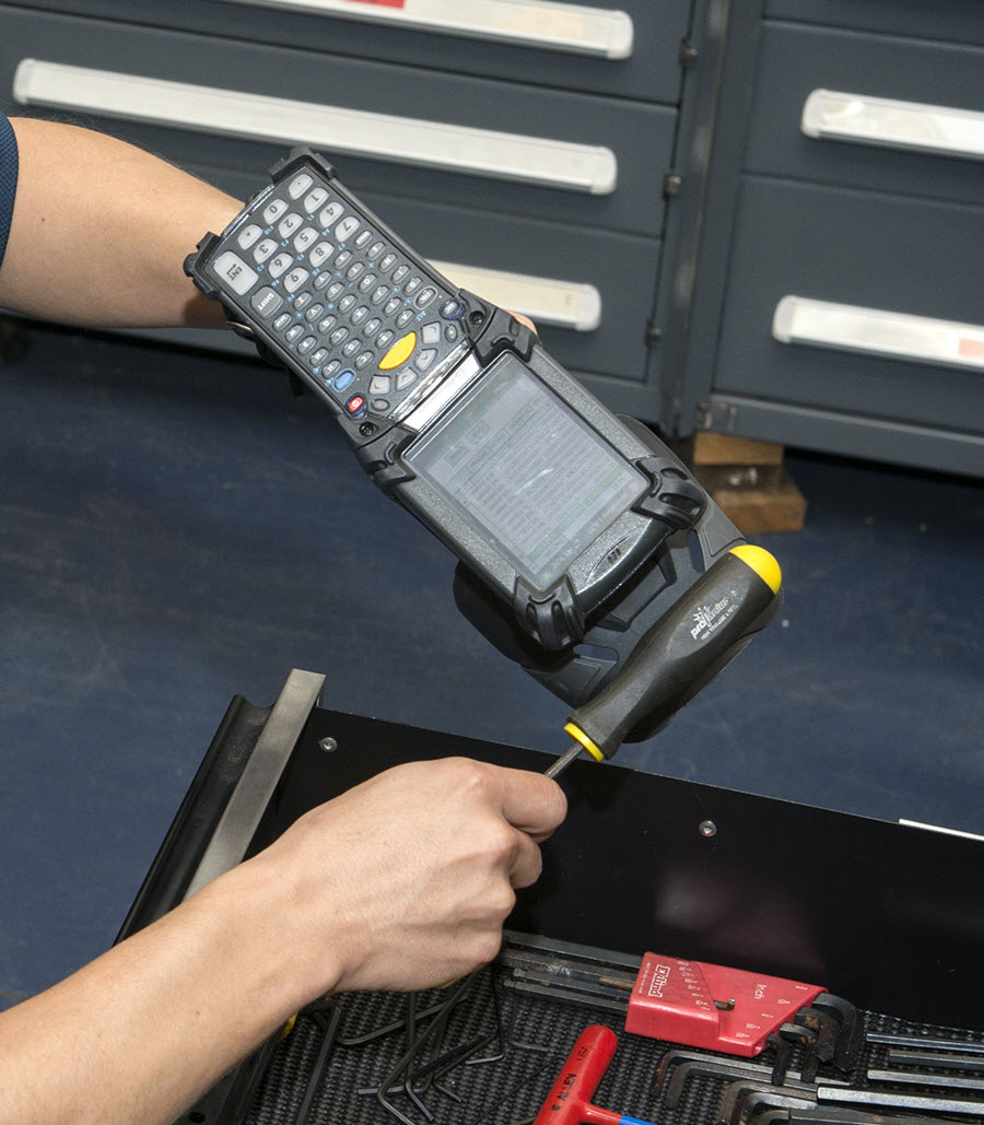 Dustin Barnes, a research analyst with Innovative Professional Solutions, Inc., scans Radio Frequency Identification Device (RFID) tags attached to tools as part of an inventory demonstration. The tags are part of the Mission Package Automated Inventory Information System (MPAIIS) which reduces inventory labor costs. The system, developed at Naval Surface Warfare Center Panama City Division (NSWC PCD), recently received authority to operate by U.S. Navy standards. Photo by Ron Newsome, NSWC PCD.