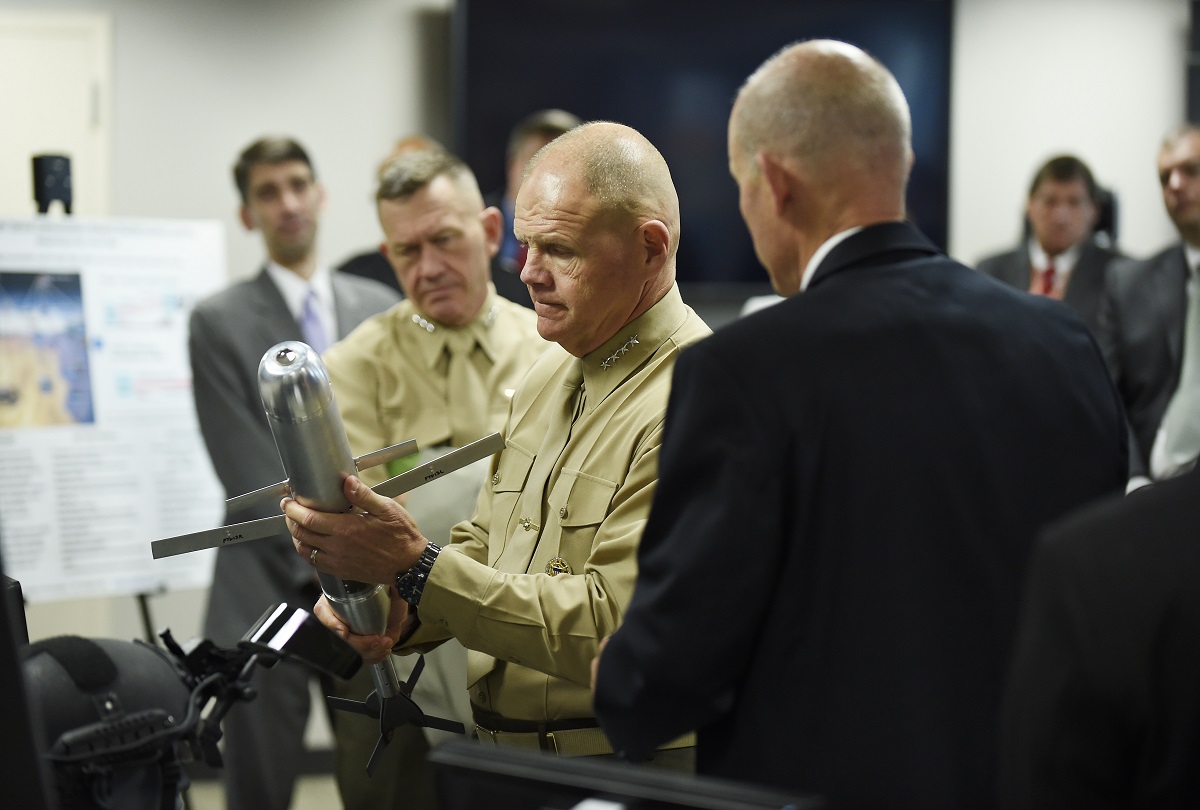 Commandant of the Marine Corps, Gen. Robert Neller, is briefed on the Advanced Capability Extended Range Mortar (ACERM) during an Office of Naval Research (ONR) awareness day. The ACERM uses dual-mode guidance, advanced aerodynamics and improved propellants to increase the performance significantly beyond that of current systems. U.S. Navy photo by John F. Williams/Released