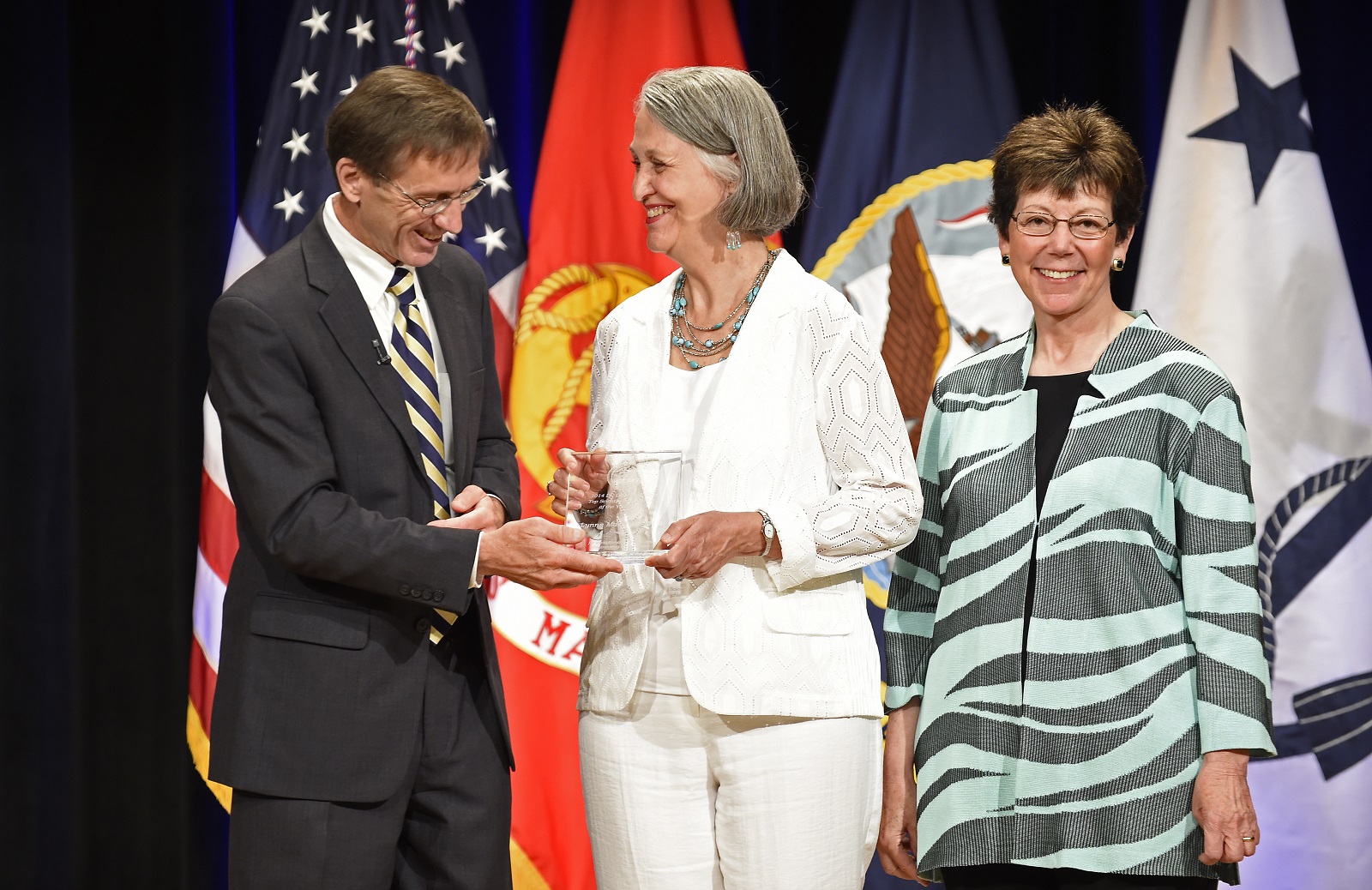 Sean J. Stackley, assistant secretary of the Navy for research development and acquisition, and Dr. Delores M. Etter present Dr. Lynne Marshall, formerly of the Naval Submarine Medical Research Laboratory, with a 2014 Dr. Delores M. Etter Top Scientists and Engineers Award. Until her retirement, Marshall was a long-time principal investigator supported by the Office of Naval Research Noise-Induced Hearing Loss Program for her work in the area of otoacoustic emissions. U.S. Navy photo by John F. Williams.