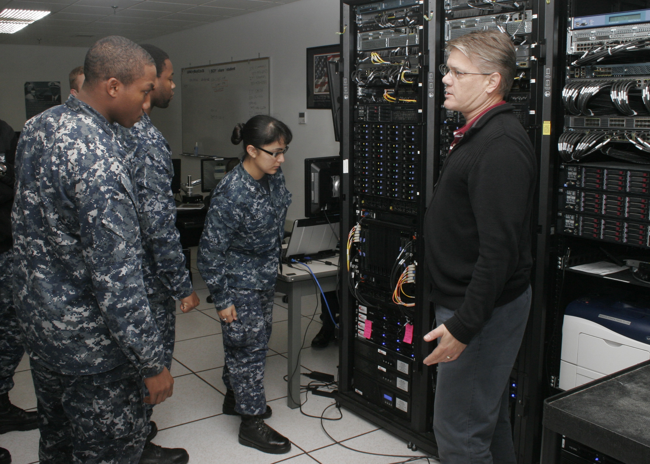 Instructor John Carver demonstrates how to identify components of the Consolidated Afloat Networks and Enterprise Services (CANES) system during CANES "C" school at Information Warfare Training Command (IWTC) Virginia Beach. U.S. Navy photo by Petty Officer 2nd Class Jay Teerlink.