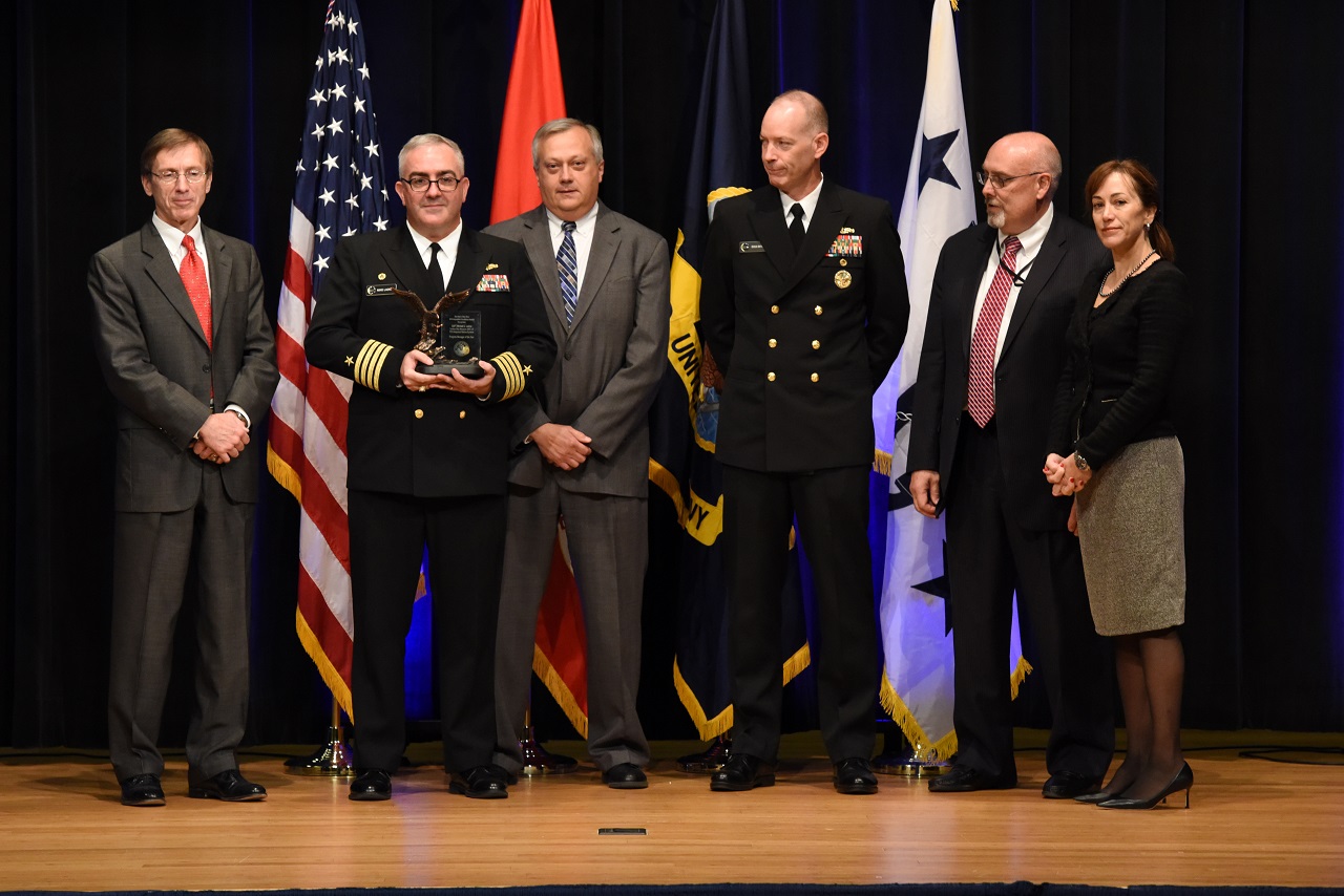 WASHINGTON (Nov. 17, 2016) Capt. Michael C. Ladner receives the Program Manager of the Year award at the Department of the Navy Acquisition Excellence Awards ceremony at the Pentagon. The annual acquisition awards recognize individuals and teams for executing creative, effective and cost-saving acquisition practices.  U.S. Navy photo by Petty Officer 1st Class Jason Behnke/Released 