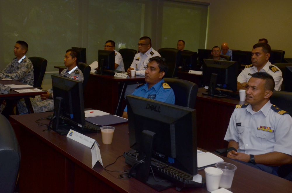 SINGAPORE (Aug. 16, 2016) Liasion officers from participating countries of Southeast Asia Cooperation and Training (SEACAT) 2016 review a training brief to prepare for the simulation exercise at Yankee Station, Aug. 16. SEACAT is multilateral exercise held annually with nine participating countries including the United States, Brunei, Indonesia, Malaysia, the Philippines, Cambodia, Bangladesh, Singapore, and Thailand. U.S. Navy Photo by Mass Communication Specialist 3rd Class Madailein Abbott/Released  