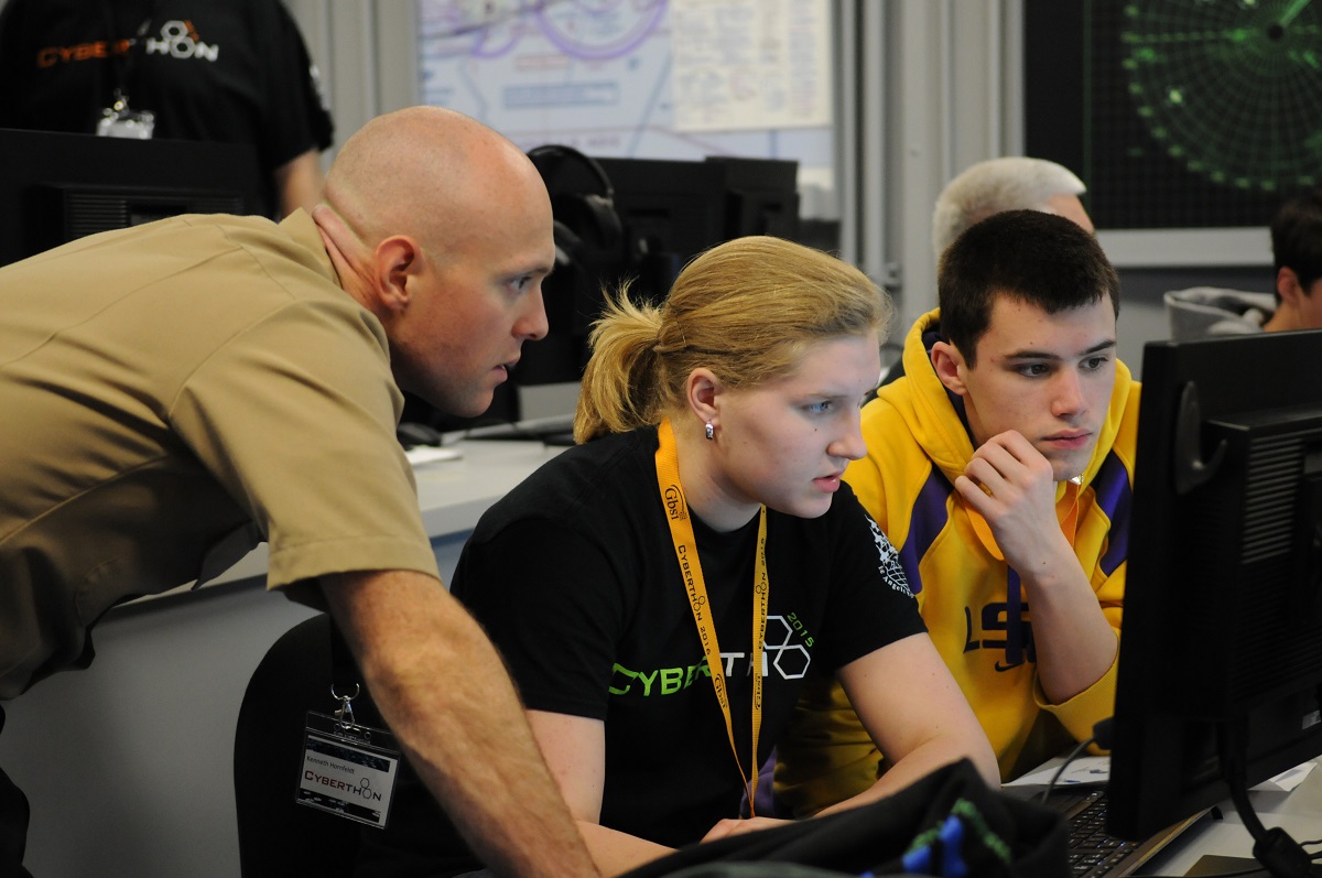 PENSACOLA, Fla. (Jan. 23, 2016) Cryptologic Technician (Collection) 1st Class Kenneth Hornfeldt, a "C" school instructor from the Center for Information Dominance Unit Corry Station, mentors high school students during CyberThon, an event designed to develop the future cybersecurity workforce.  Hosted by the Blue Angels Chapter of the Armed Forces Communications and Electronics Association, CyberThon challenged the students to play the role of newly hired information technology professionals tasked with defending their company's network.  U.S. Navy photo by Carla M. McCarthy 