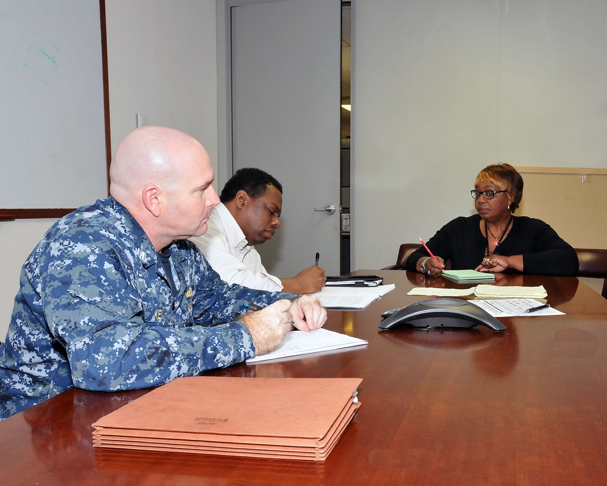 DAHLGREN, Va. (December 17, 2015) Center for Surface Combat Systems Staff Joint Interface Control Officer (JICO) Lt. Patrick Key discusses Cybersecurity curriculum with Ms. Jessie Harris, the Learning Standards Officer, and Mr. Eddie Taylor, a CSCS Training Specialist. U.S. Navy photo by Daryl Roy, AEGIS Training and Readiness Center