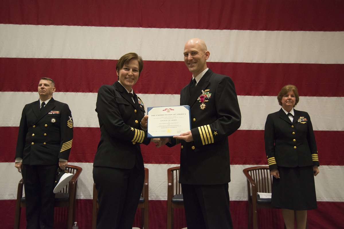 NAVY INFORMATION DOMINANCE FORCES, Suffolk, Va. (December 04, 2015) -- Capt. Kelly Aeschbach, Chief of Staff, Navy Information Dominance Forces, presents Capt. Michael “Barry” Tanner with the Legion of Merit for his exceptionally meritorious service from December 2013 to November 2015 as Commander, Navy Reserve Navy Information Dominance Forces Operations.  The award was received during the NR NAVIDFOR Ops change of command ceremony held in the Navy Global Network Operations and Security Center, Dec. 4. U.S. Navy photo by Michael J. Morris 