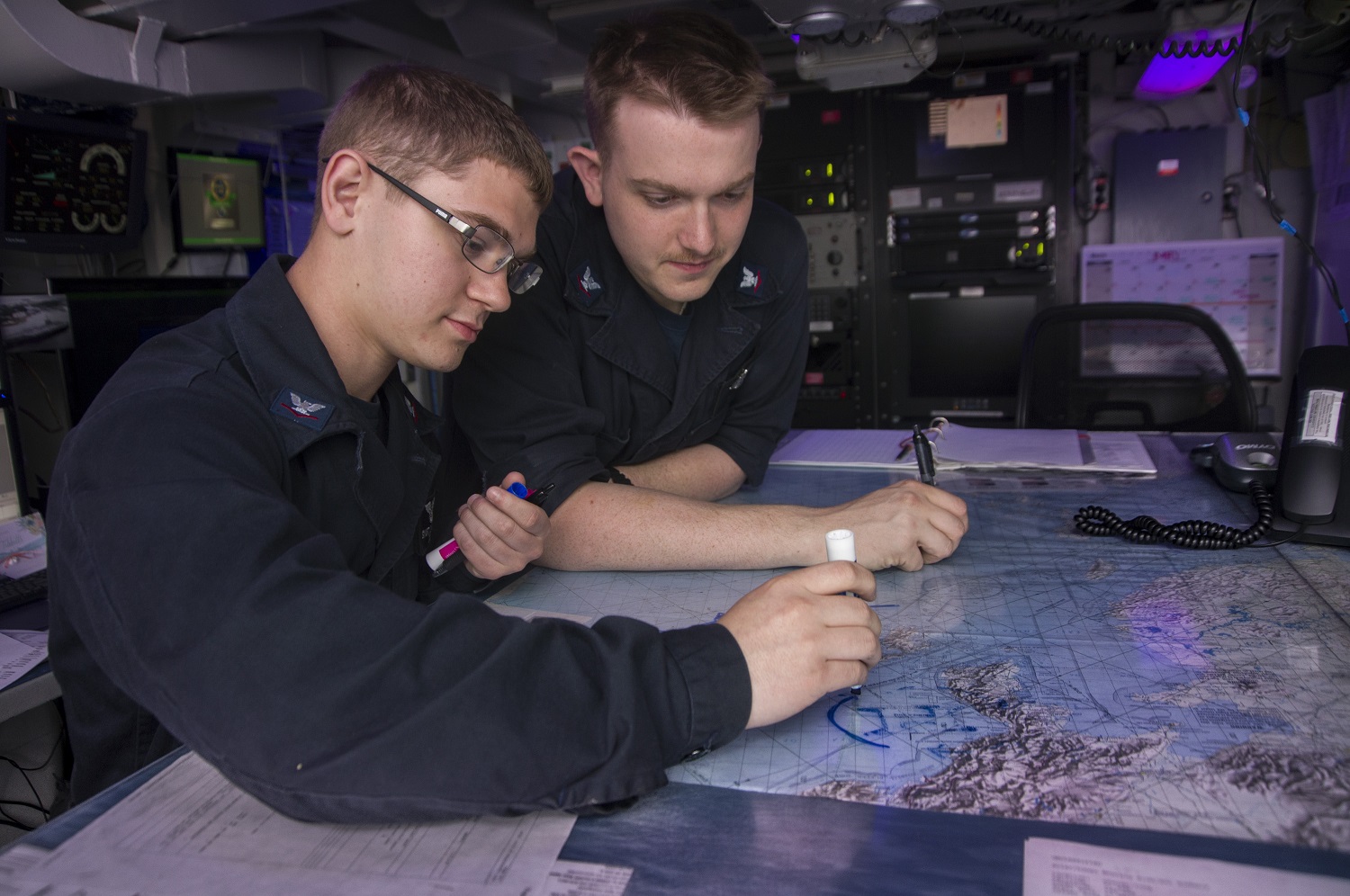 WATERS SOUTH OF JAPAN (May 22, 2015) Aerographer’s Mates 3rd Class Dakota Swift, left, from Jackson, Mo., and Steven Watson, from Enterprise, Ala., draw a baiu front on the chart table in the meteorology office aboard the Nimitz-class aircraft carrier USS George Washington (CVN 73). George Washington and its embarked air wing, Carrier Air Wing (CVW) 5, are on patrol in the 7th Fleet area of responsibility supporting security and stability in the Indo-Asia-Pacific region. George Washington will conduct a hull-swap with the Nimitz-class aircraft carrier USS Ronald Reagan (CVN 76) later this year after serving seven years as the U.S. Navy’s only forward-deployed aircraft carrier in Yokosuka, Japan.  U.S. Navy photo by Mass Communication Specialist Seaman Bryan Mai 