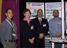 CHIPS webmaster, Tony Virata, CHIPS assistant editor, Nancy Reasor,
Space and Naval Warfare Systems Center (SSC) Atlantic employees,
Anthony Carbone and Kris Fogle, at the Team SPAWAR exhibit at the Joint
Warfighting Conference in May.